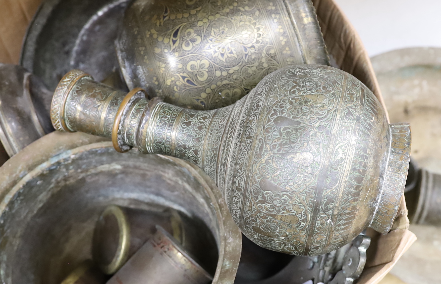 A group of 19th and early 20th century Indian brass and copper vessels, dishes, a vase, measures, etc. largest dish 46.5cm diameter